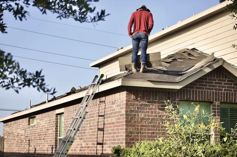 Professional roofer working on a residential roof in New North Roland Park - Poplar Hill